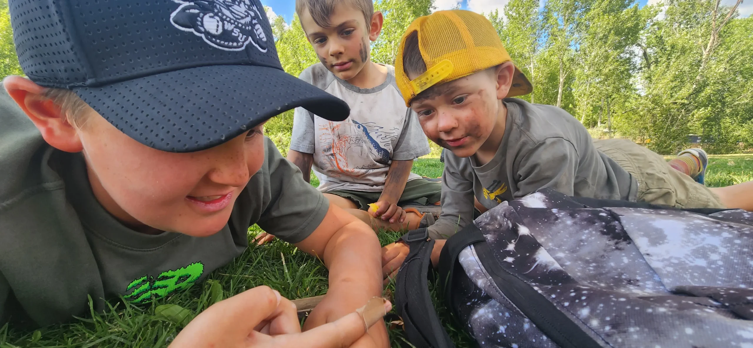 Children examining a worm.