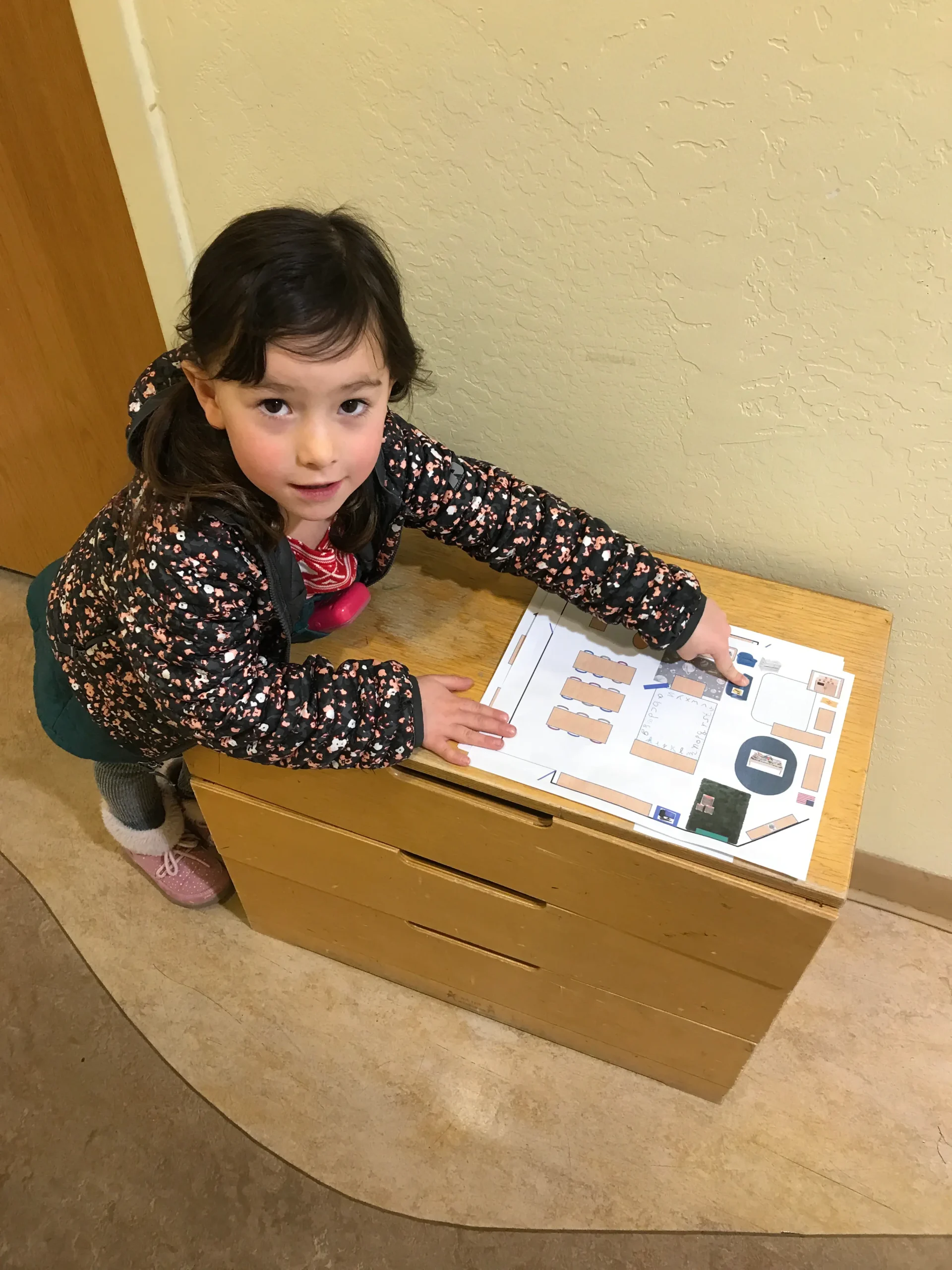 A four-year-old arranges the furnishings of the dollhouse at the Santa Fe Children's Museum.